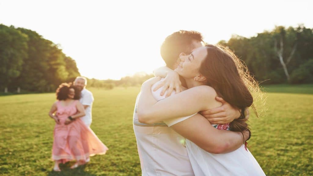 A couple hugging in the park