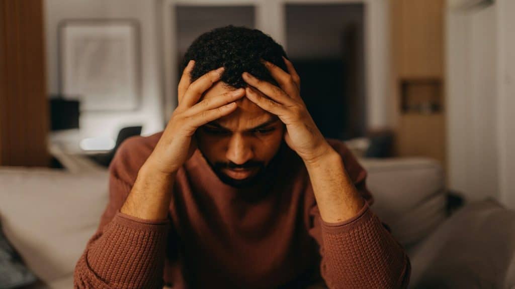 A man looking stressed at home