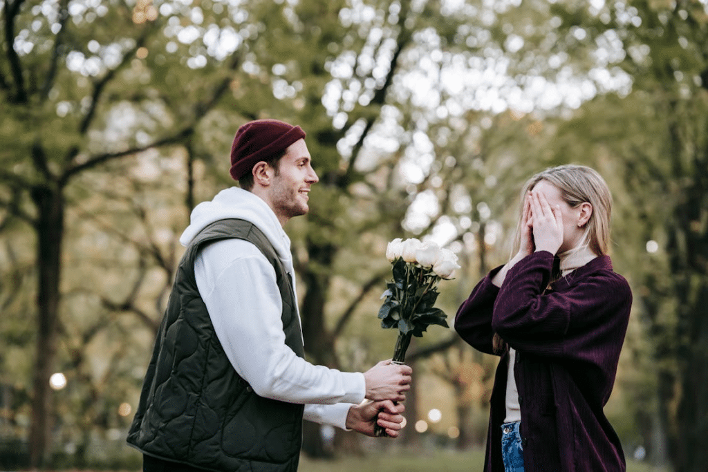 A man surprises his girlfriend with a flower