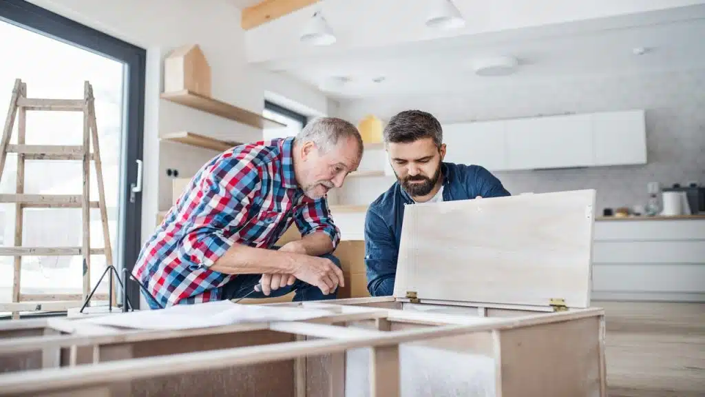 A father and son assembling furniture