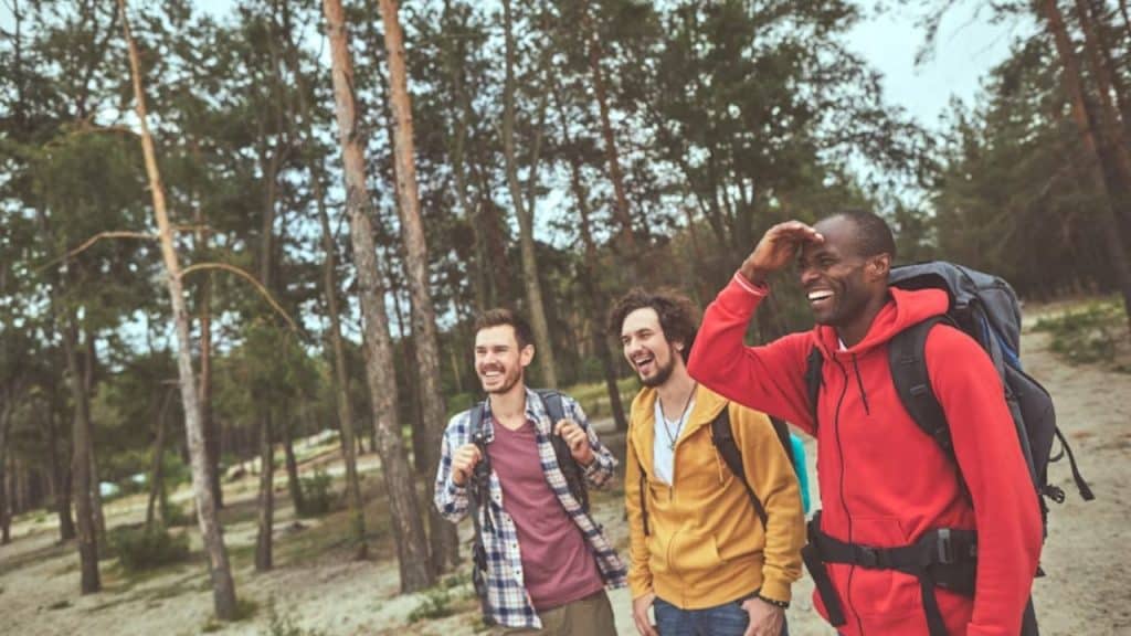 A group of men hiking outdoors together, laughing and bonding.