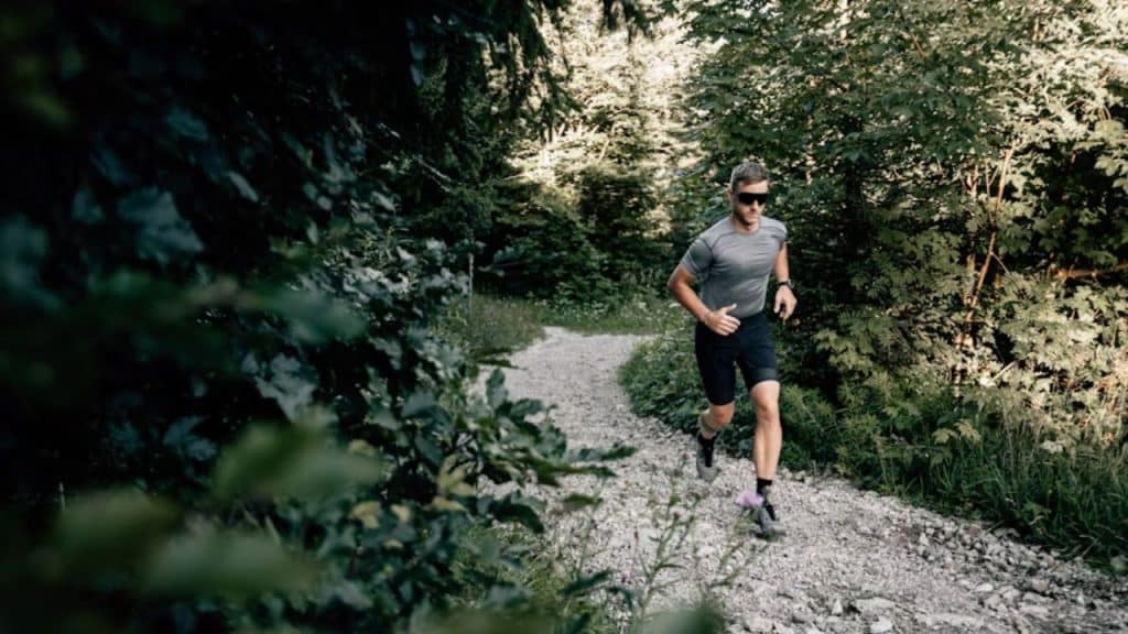 A man jogging at sunrise, focused and motivated.