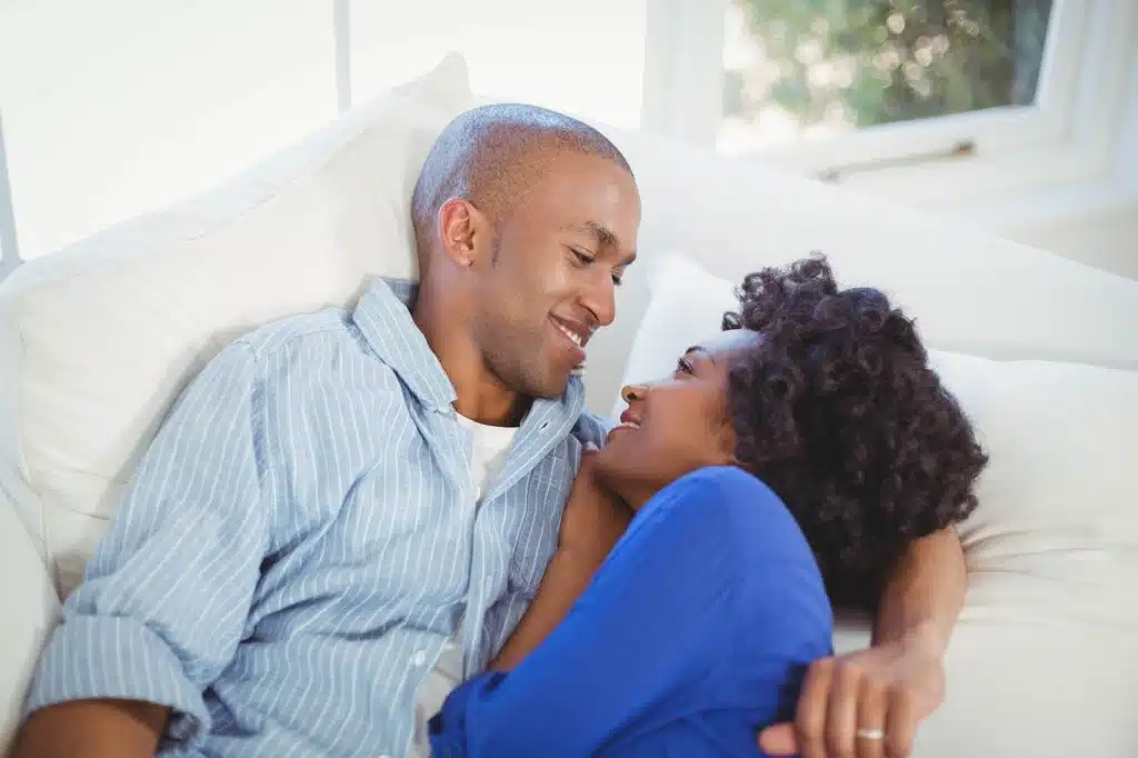 Happy couple lying on the sofa in the living room