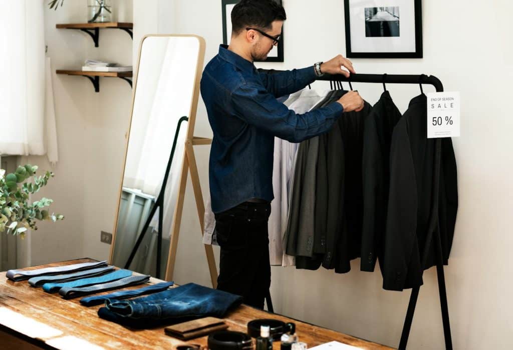 The man is shopping for clothes.