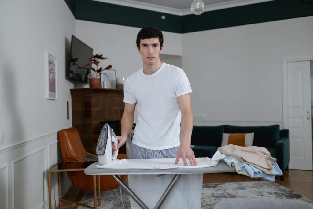 The man is ironing a shirt.