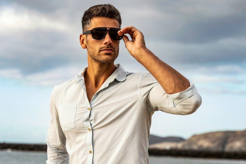 The man is wearing sunglasses while outdoors.