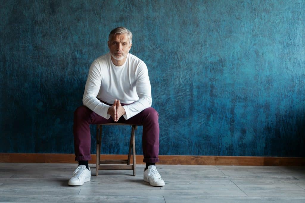 The man is wearing white sneakers.