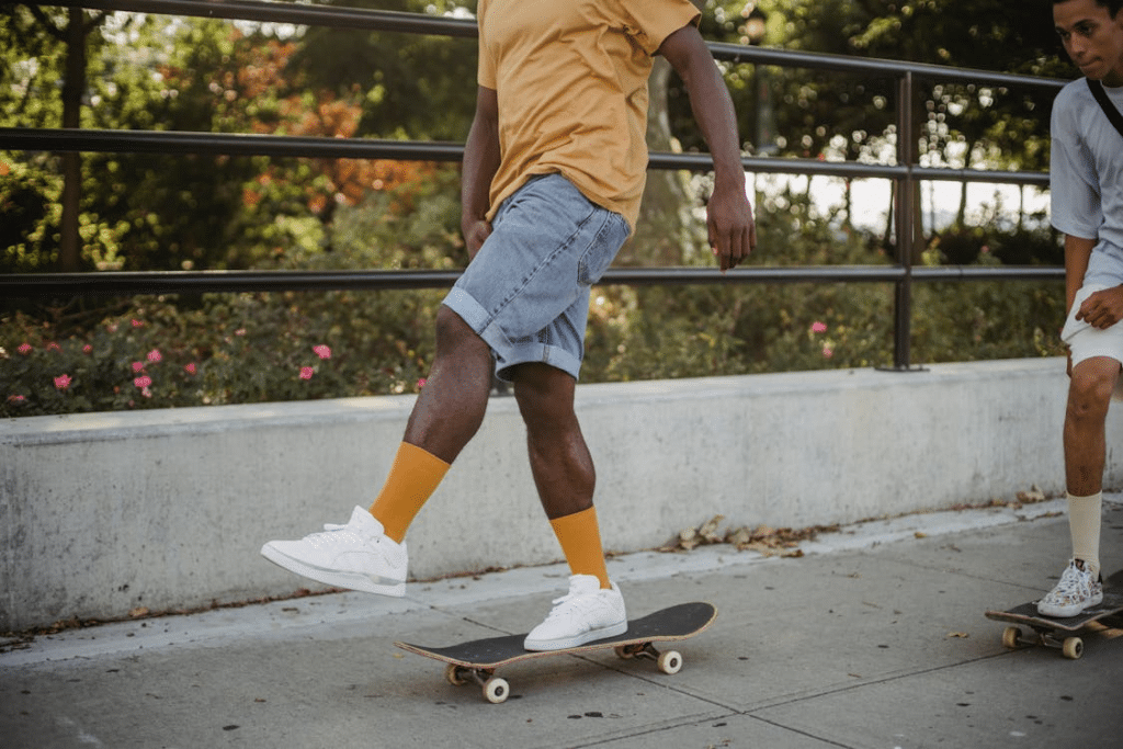 A man wearing white sneakers on a skateboard