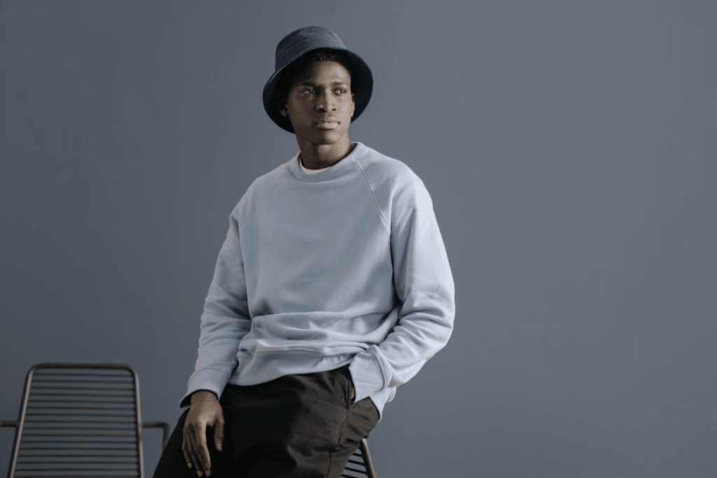 Man in Pastel Blue Sweater Posing with his Hand inside the Pocket