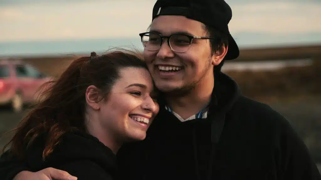 A Man hugging his partner.