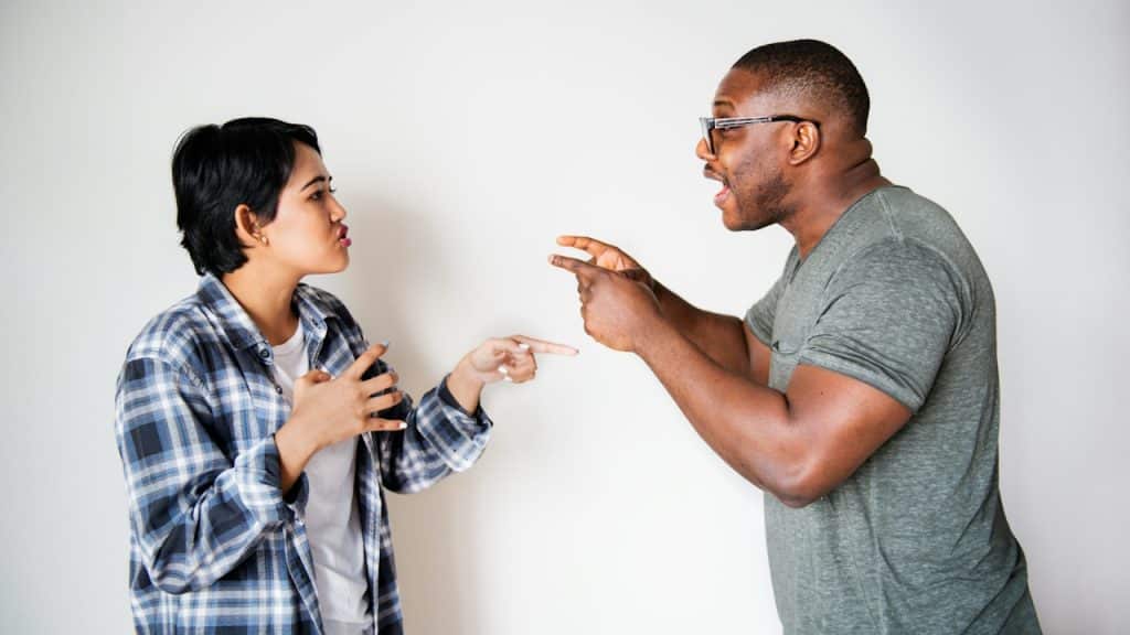 A couple arguing animatedly.