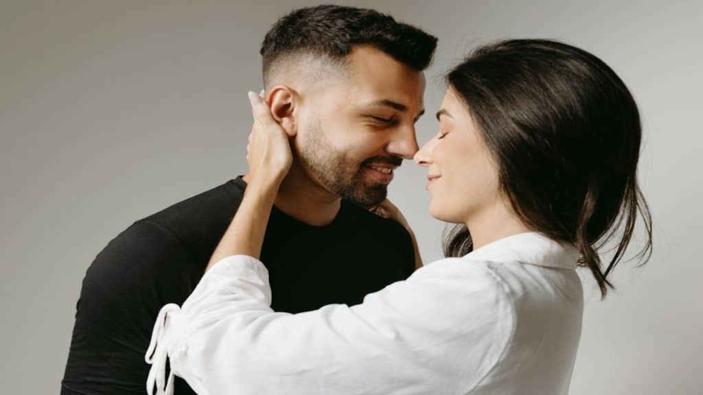 A man and a woman embracing each other.