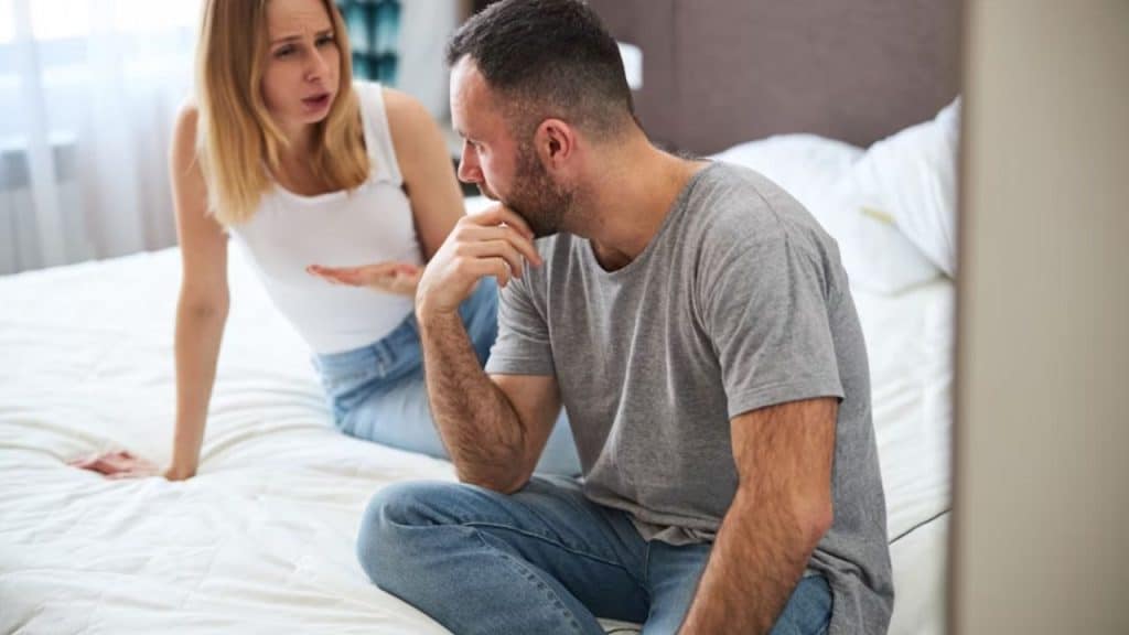 A woman responding with minimal words while her husband speaks