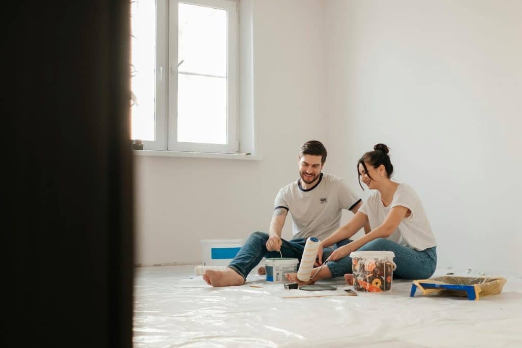 The couple is sitting on the floor.