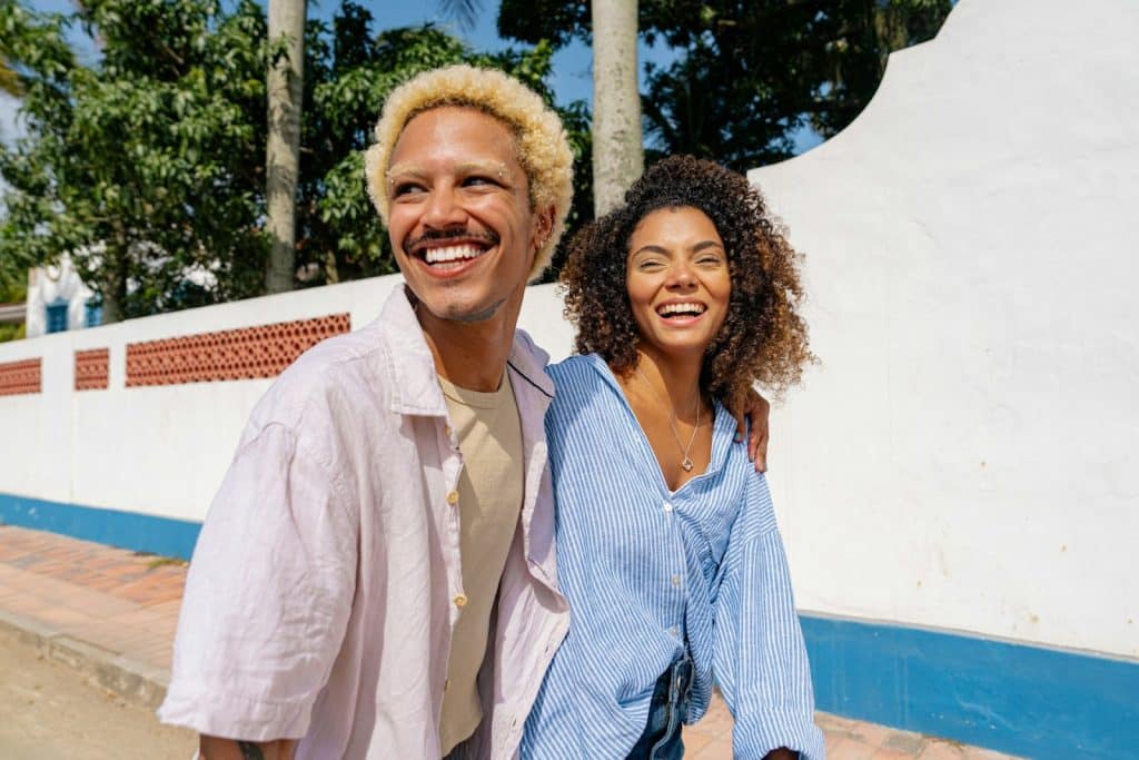 The man and woman are walking down the street.