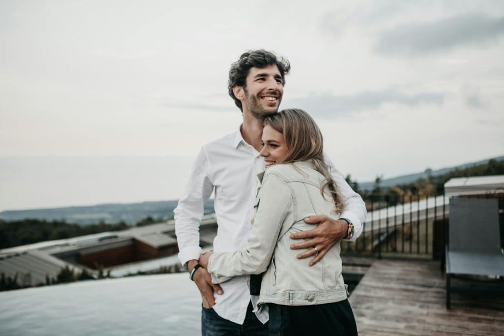 The man and woman are hugging each other.