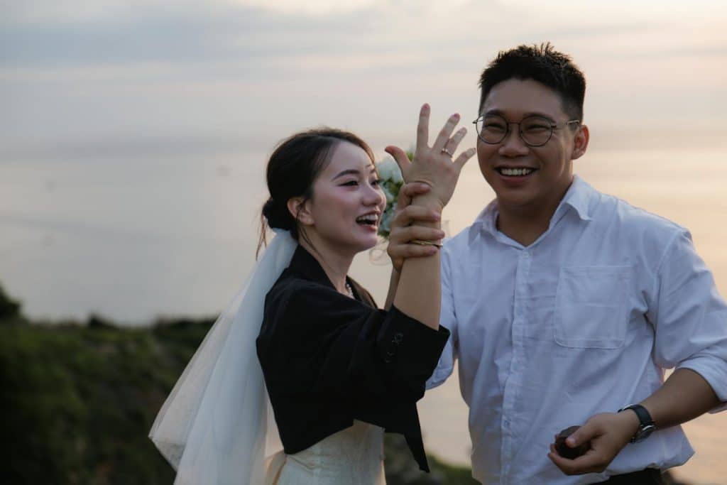 A couple showing the woman’s ring in her finger.