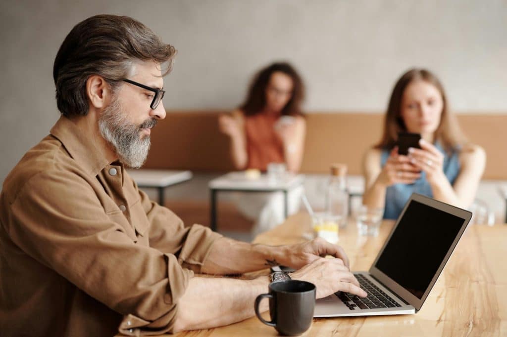 A man and woman busy with their gadgets