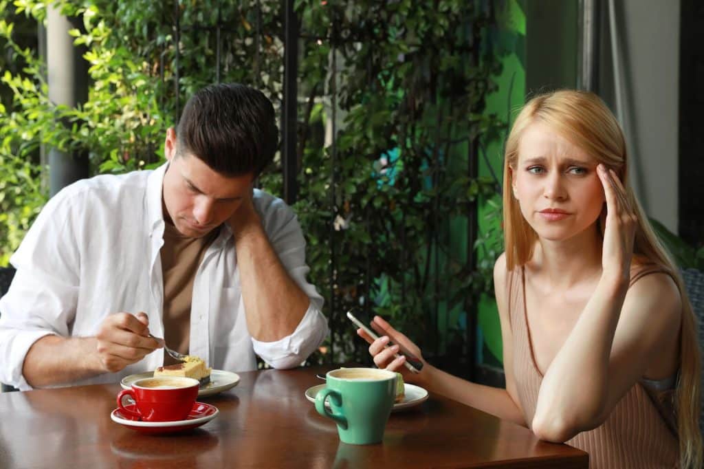 The woman is ignoring her date.