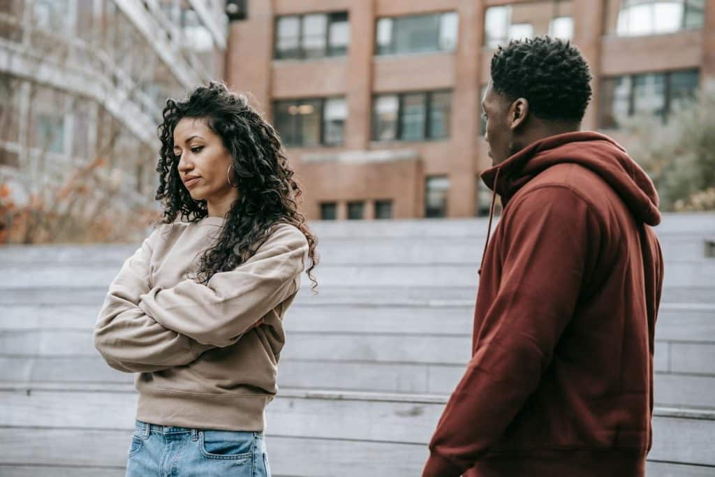 The couple is arguing in the city.