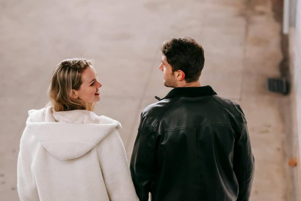 The couple is taking a stroll at night.