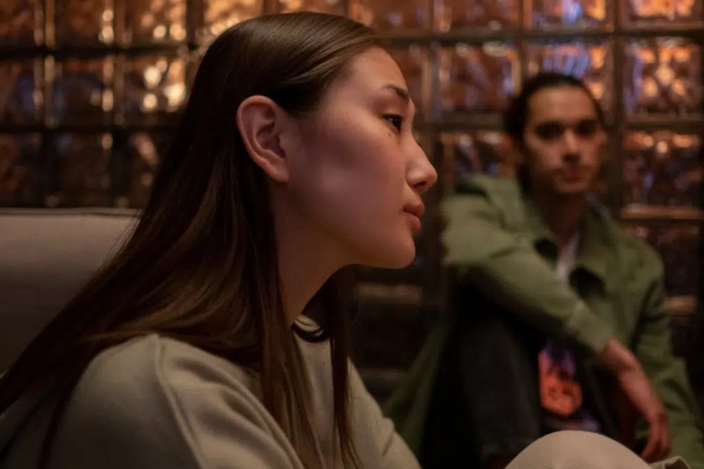 Two people sitting on floor