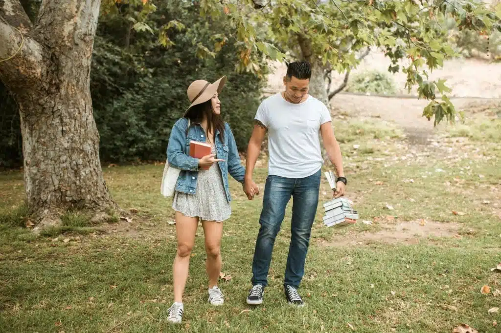 A man bringing the books of a woman