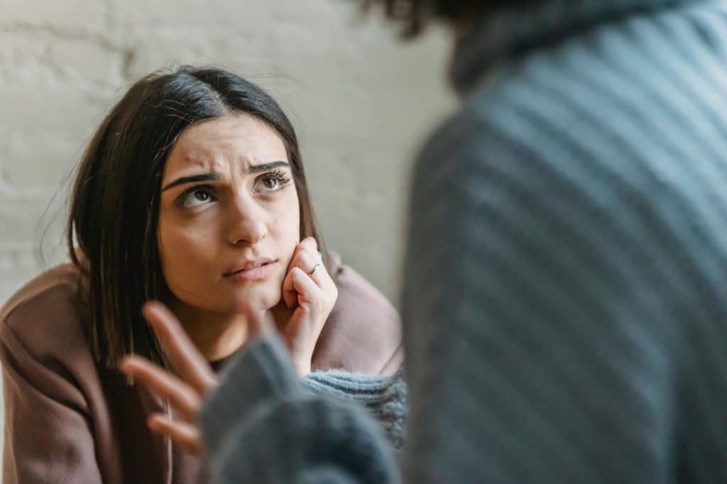 A woman looking at the man