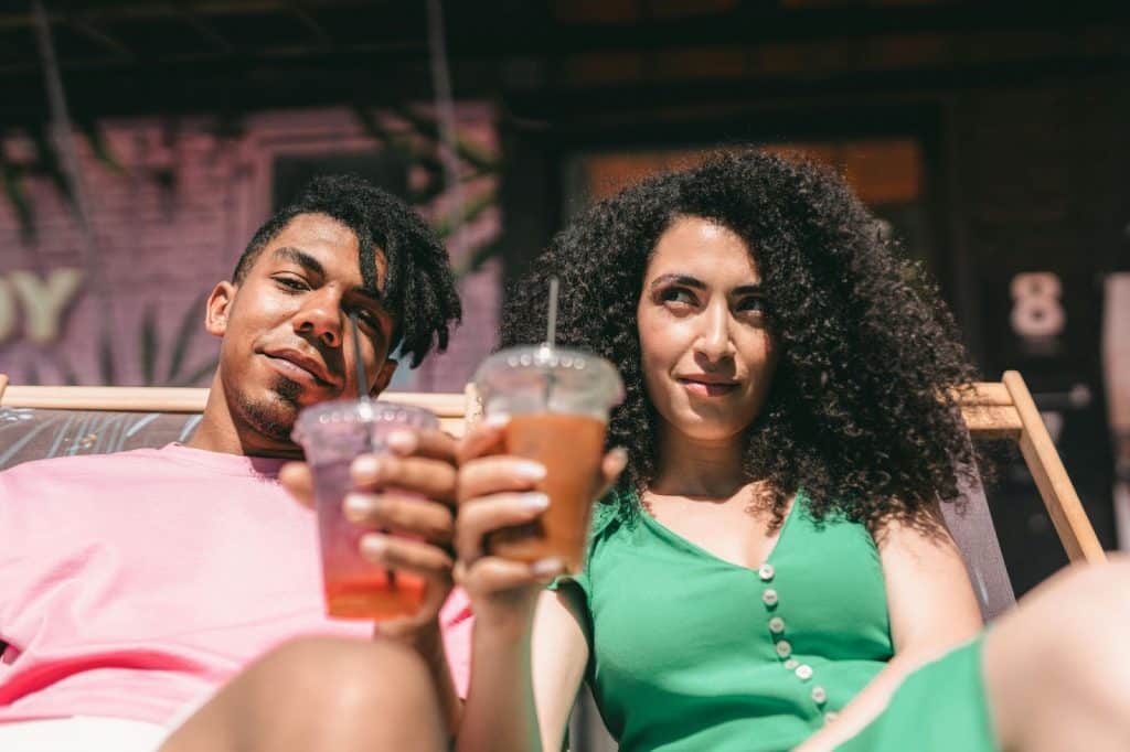 A man and woman holding a drink