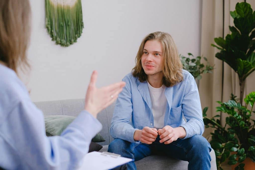 A man listening to a woman