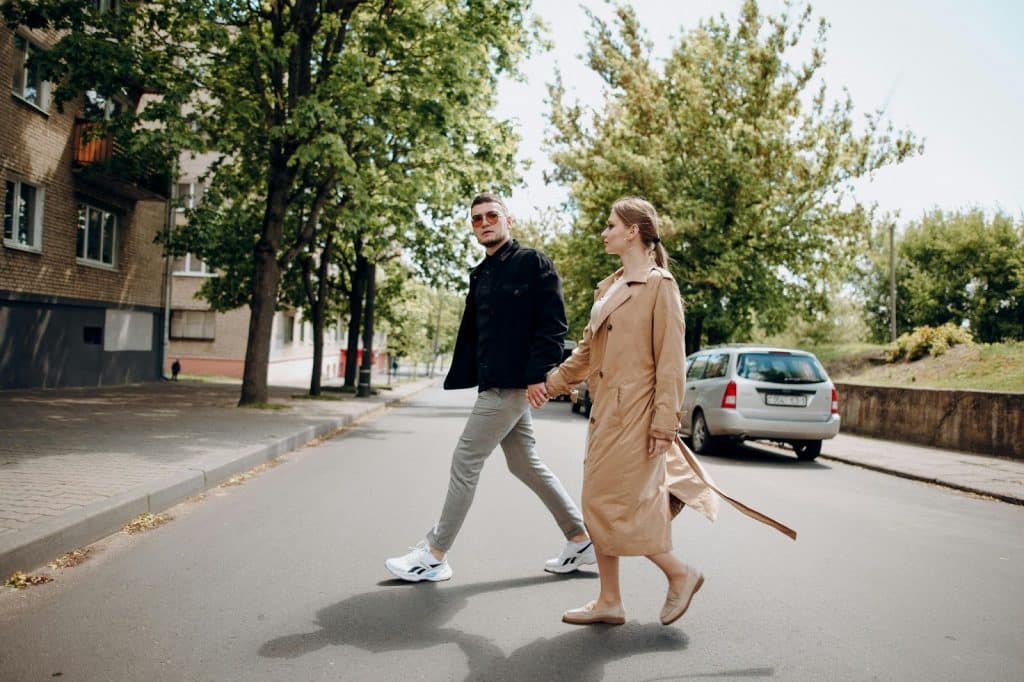 A man and woman walking outside