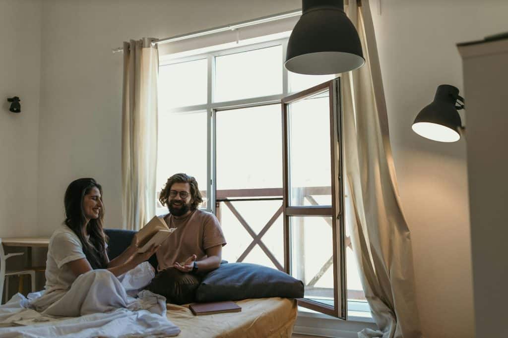 A man and woman at the bed