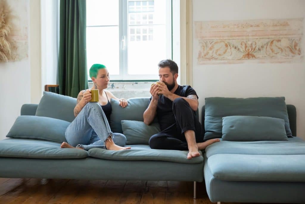 A man letting a woman rest on his lap