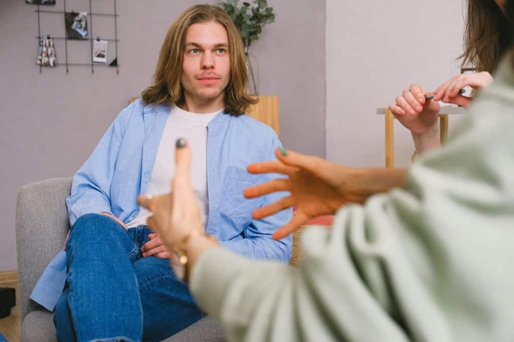 A man listening to a woman