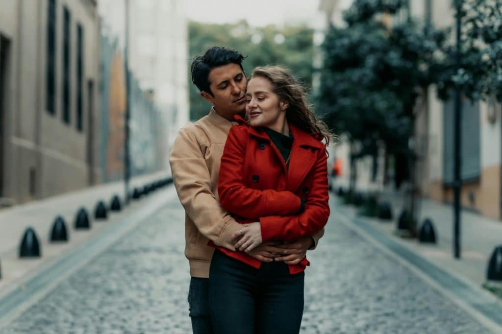 A man hugging a woman from behind