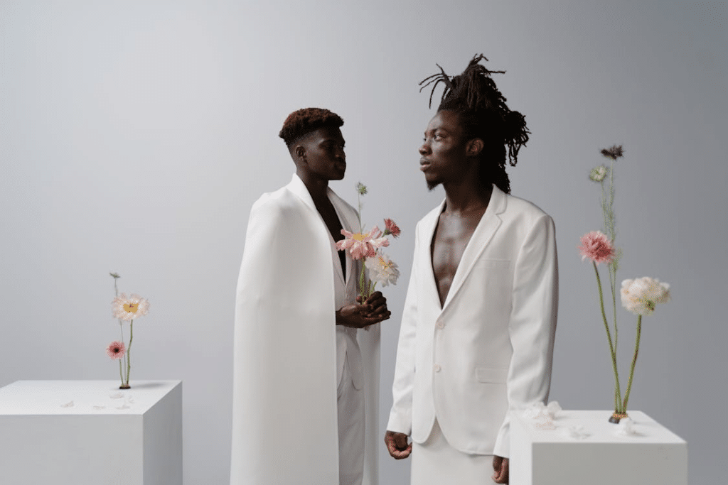 Two Men Holding Pink Flowers