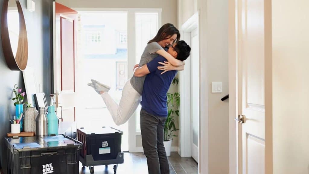 Couple embracing warmly at home