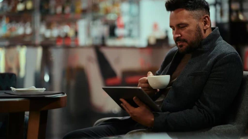 Man reading alone at a café