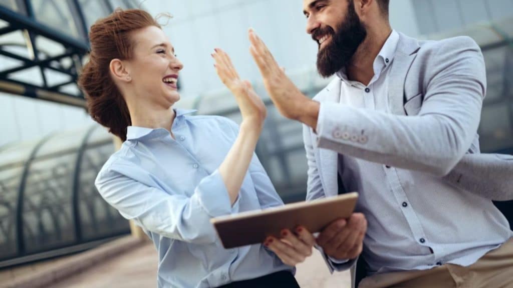 Couple high fiving after solving a shared task