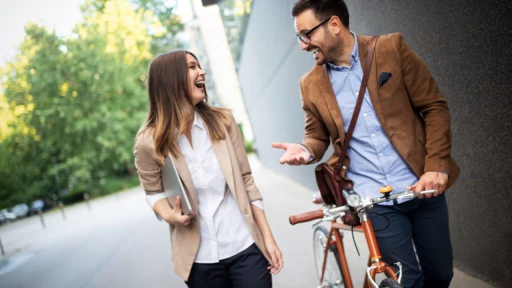 Couple walking separately but smiling at each other