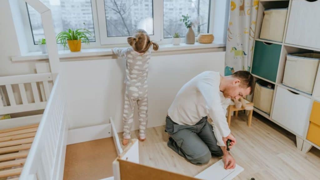 Man repairing something in the bedroom