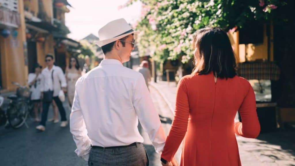 Couple holding hands while walking, symbolizing renewed intimacy