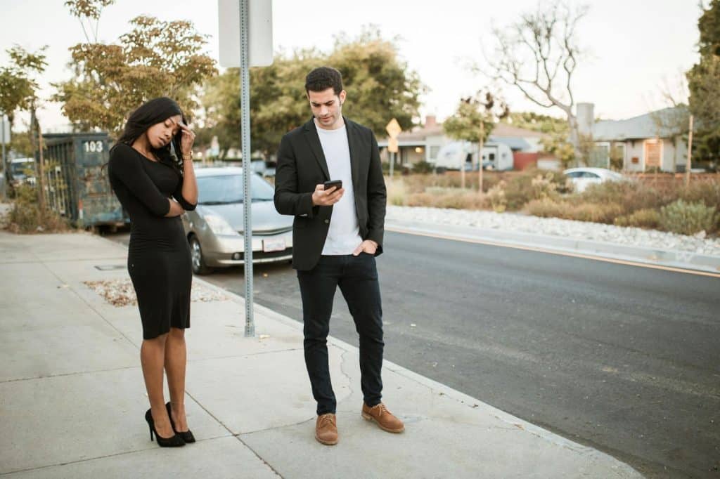 A man and woman at the sidewalk