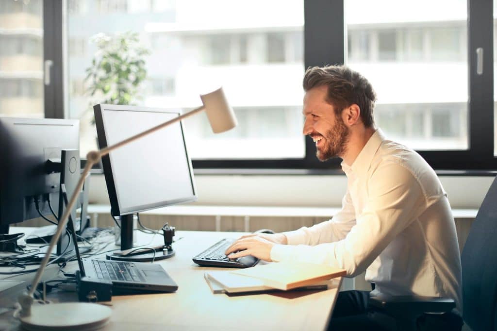 The man is working on his computer.