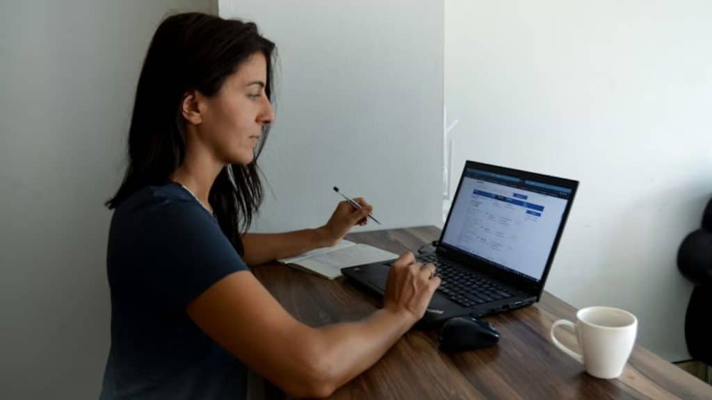 A woman making decisions on her laptop alone