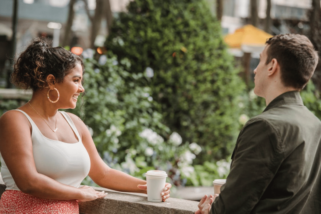 Couple drinking takeaway coffee on terrace