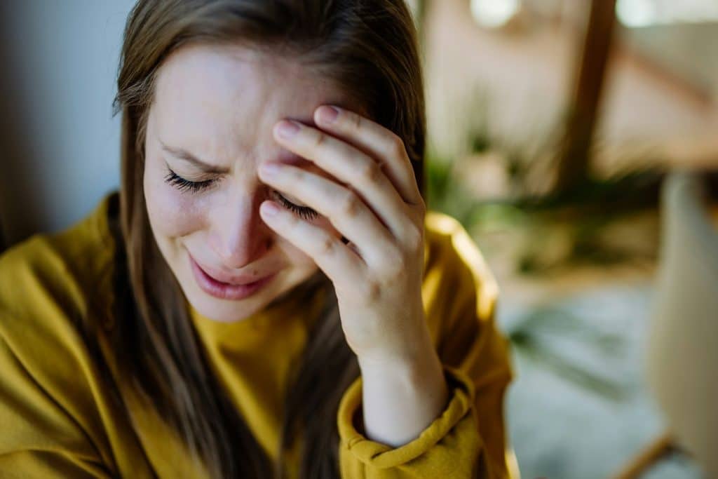 The woman is crying.