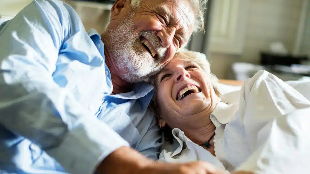 An older couple laughing together.
