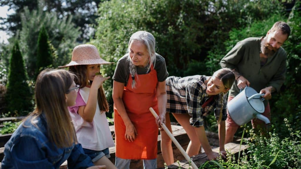 A group of people of different ages working together in a garden.