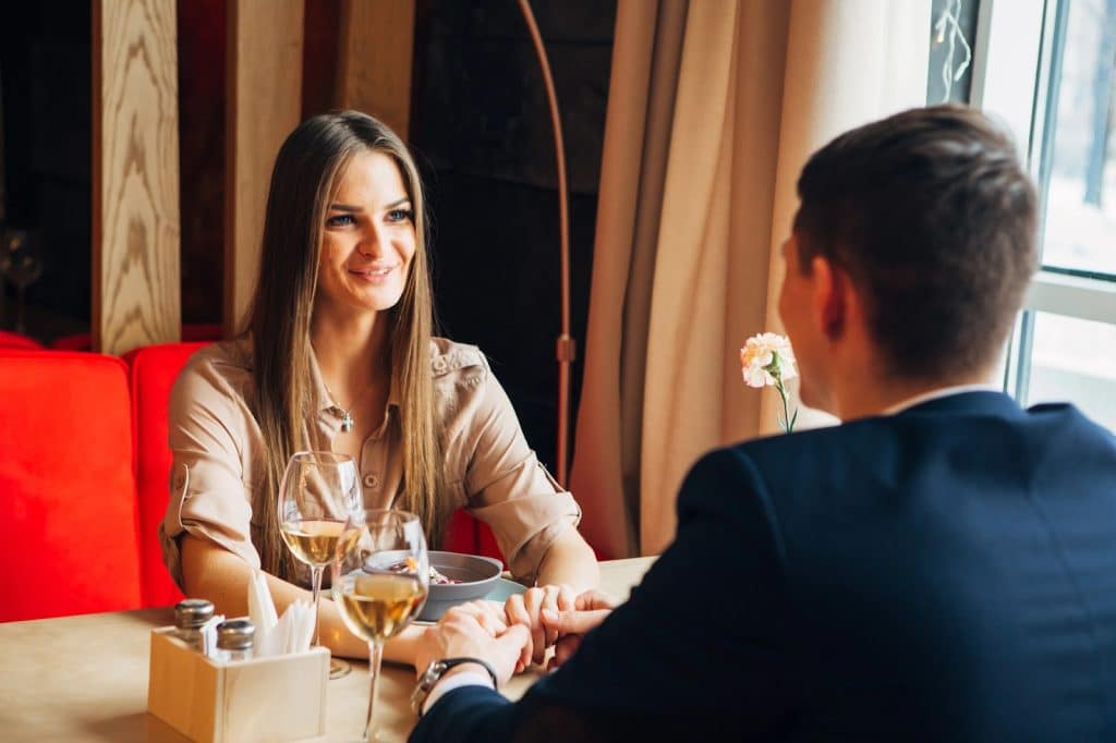 The couple is on a date at a restaurant.